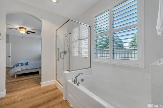 a bathroom with a tub a sink and a window