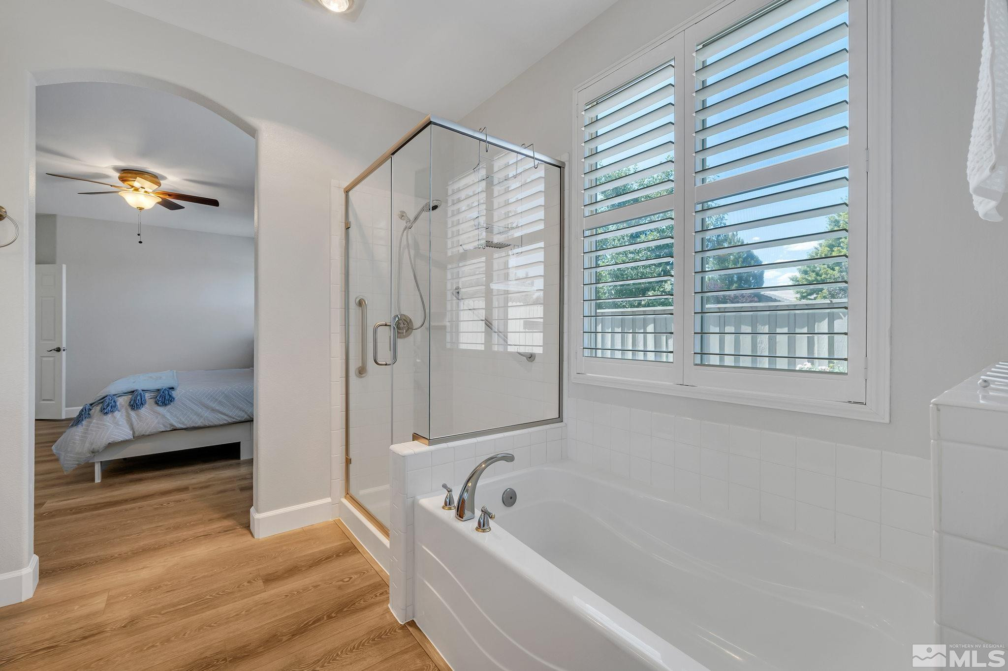 10459 Summershade Lane Reno, NV 89521 - Photo 21 of 37 a bathroom with a tub a sink and a window