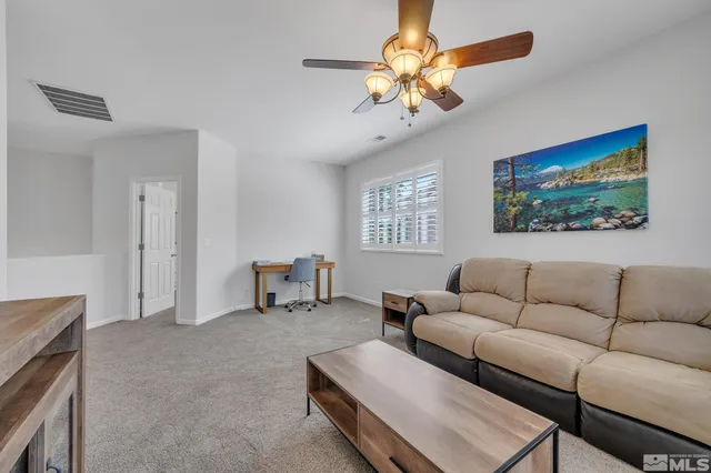 a living room with furniture a chandelier and a window