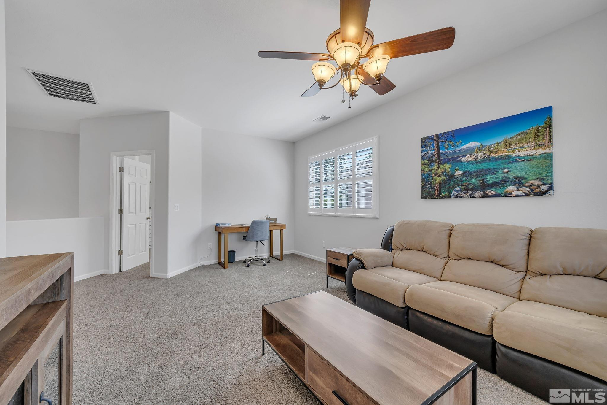 10459 Summershade Lane Reno, NV 89521 - Photo 25 of 37 a living room with furniture a chandelier and a window