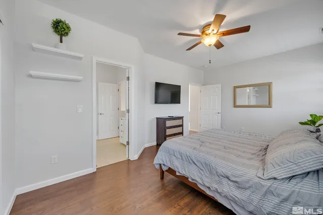 a bedroom with a bed chandelier and a window