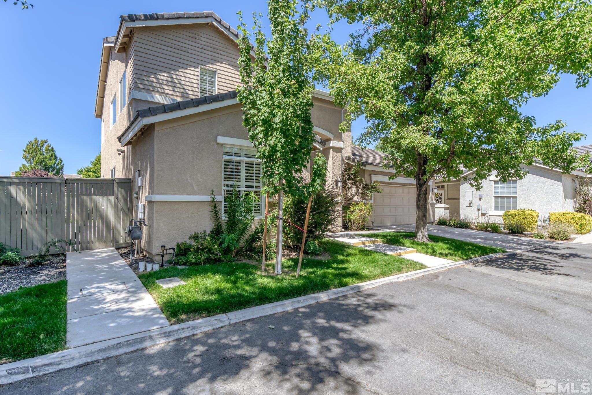 10459 Summershade Lane Reno, NV 89521 - Photo 3 of 37 a front view of a house with a yard and potted plants