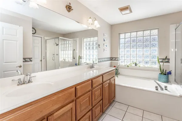 a spacious bathroom with sinks a bath tub and a sink