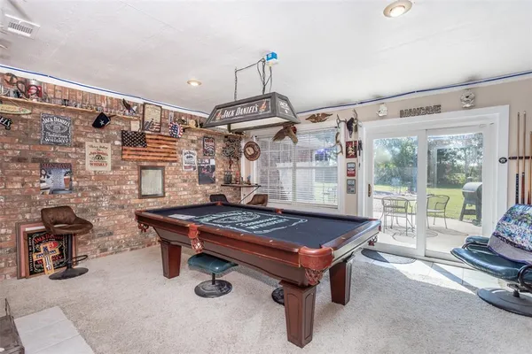 a living room with furniture a rug and white walls