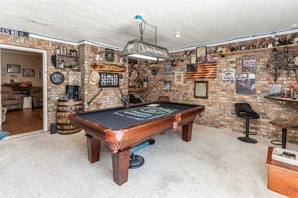 a room with pool table and musical instruments