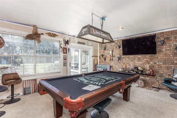 a living room with fireplace furniture and a flat screen tv