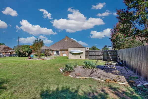 a view of a table and chairs in a yard