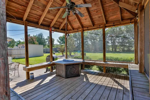 a view of a porch with wooden floor in front of it