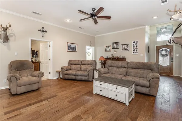a living room with furniture and a ceiling fan