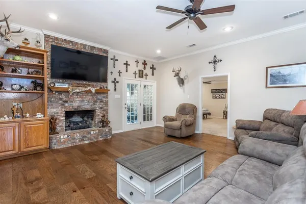 a living room with furniture a flat screen tv and a fireplace