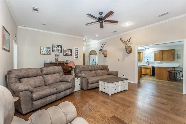 a living room with furniture and kitchen view