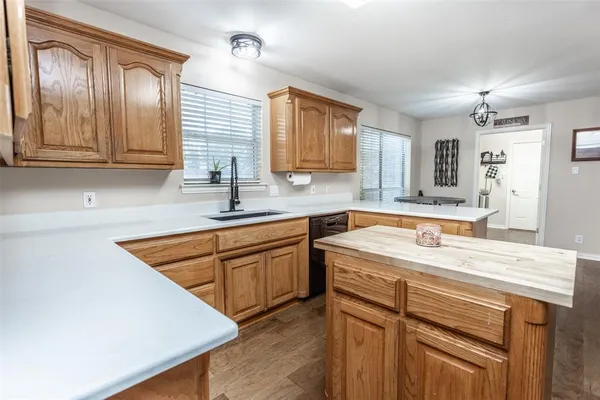 a kitchen with stainless steel appliances granite countertop a sink and dishwasher a stove with wooden floor
