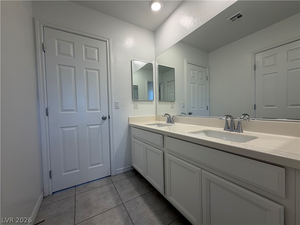 3228 Azalea Ridge Court Henderson, NV 89052 - Photo 16 of 28 A sleek vanity with dual sinks provides ample space and convenience in this well-appointed bathroom.