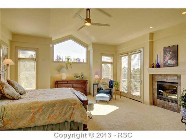 4265 Hidden Rock Road Colorado Springs, CO 80908 - Photo 14 of 25 Spacious Main Level Master Suite w/ Fireplace, Walk-out to Deck, 5-Piece Master Bath & Custom Walk-in Closet w/ Built-in Ironing Board