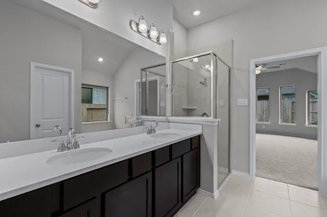 a bathroom with a double vanity sink and a mirror