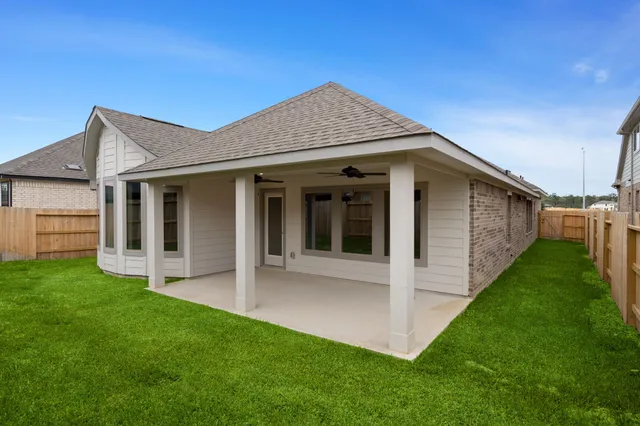 a front view of a house with a garden and plants
