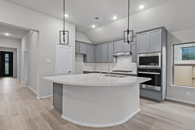 a large kitchen with stainless steel appliances kitchen island a large island in the center