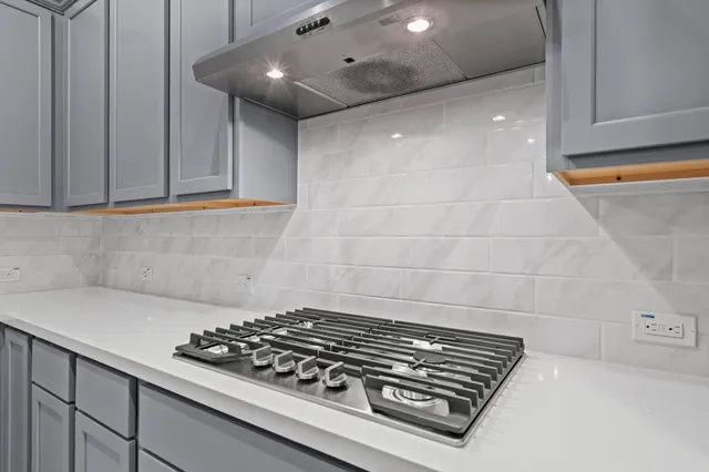a stove top oven sitting inside of a kitchen
