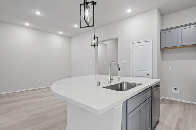 a view of a kitchen with a sink and a refrigerator
