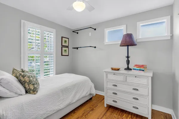 a spacious bedroom with a bed and a chandelier