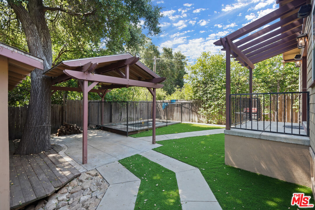 910 Bell Street Pasadena, CA 91104 - Photo 16 of 32 a view of a chair and table in backyard of the house