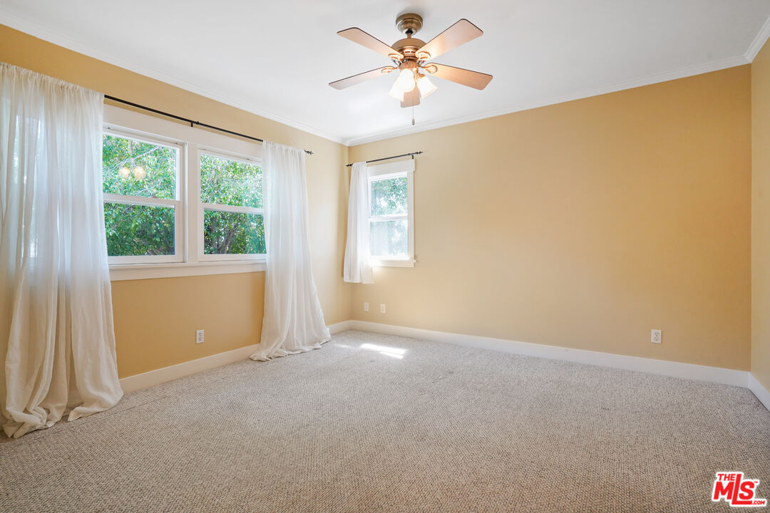 910 Bell Street Pasadena, CA 91104 - Photo 19 of 32 an empty room with windows and fan