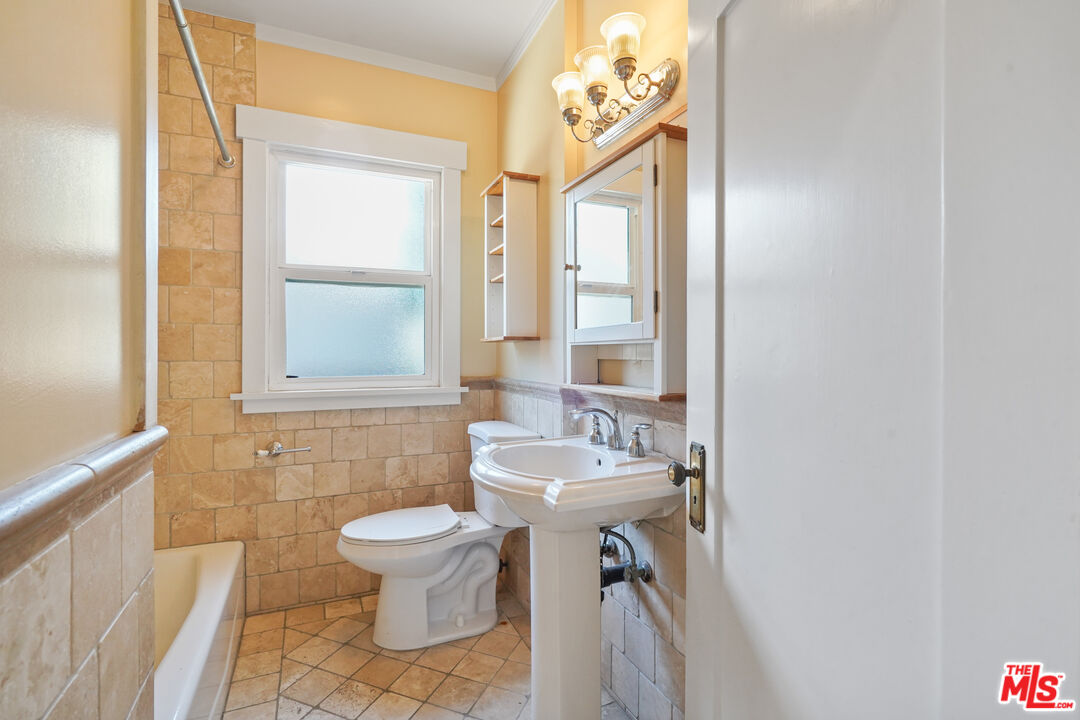 910 Bell Street Pasadena, CA 91104 - Photo 22 of 32 a bathroom with a sink a toilet and a mirror