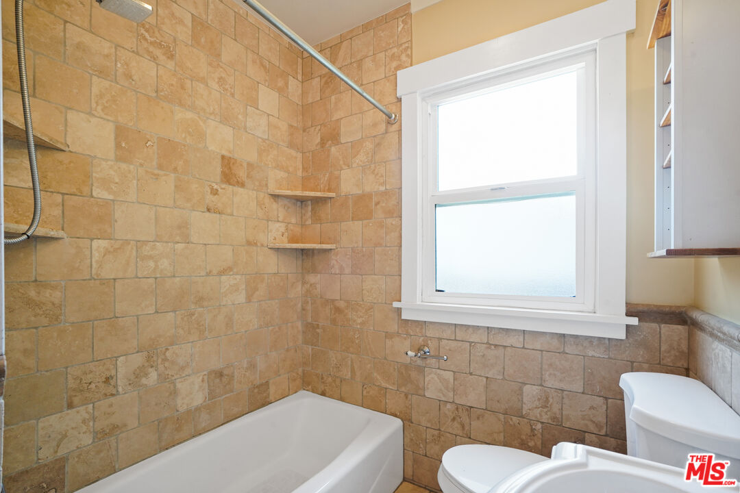 910 Bell Street Pasadena, CA 91104 - Photo 23 of 32 a bathroom with a toilet sink and mirror