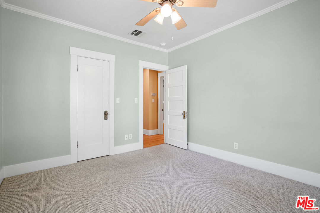 910 Bell Street Pasadena, CA 91104 - Photo 26 of 32 an empty room with a chandelier fan and windows
