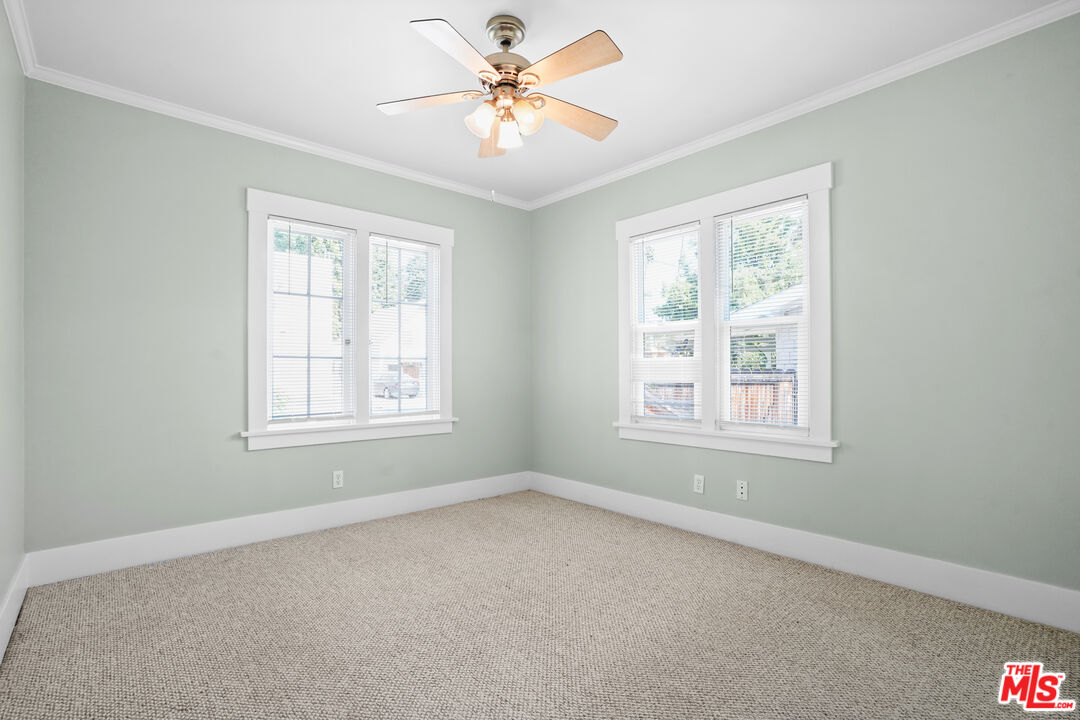 910 Bell Street Pasadena, CA 91104 - Photo 28 of 32 an empty room with windows and fan
