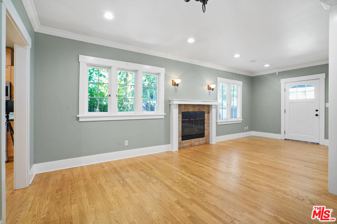 910 Bell Street Pasadena, CA 91104 - Photo 3 of 32 a view of empty room with kitchen and fireplace