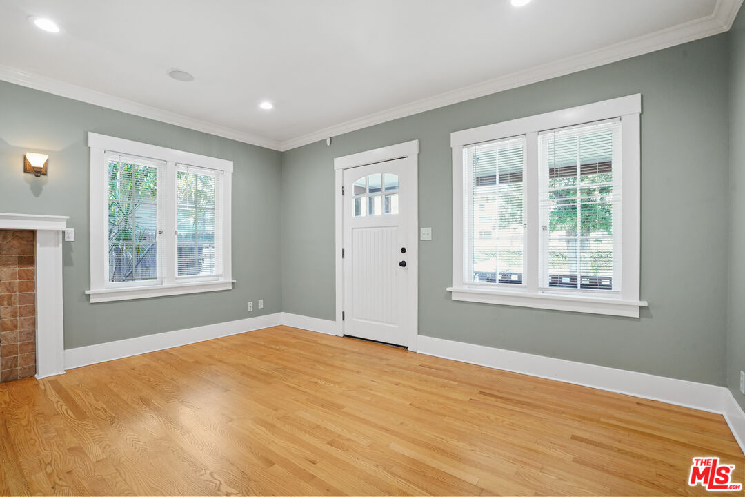 910 Bell Street Pasadena, CA 91104 - Photo 4 of 32 a view of an empty room with wooden floor and a window