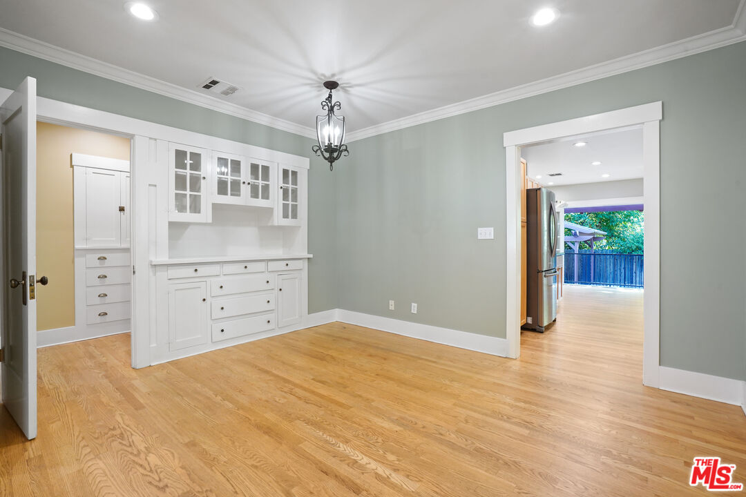 910 Bell Street Pasadena, CA 91104 - Photo 6 of 32 an empty room with cabinet and wooden floor