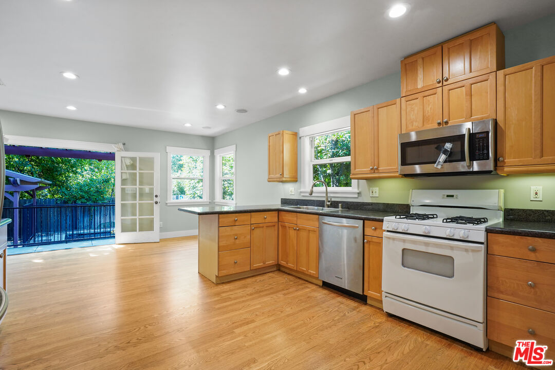 910 Bell Street Pasadena, CA 91104 - Photo 7 of 32 a kitchen with stainless steel appliances granite countertop a stove a sink and a microwave