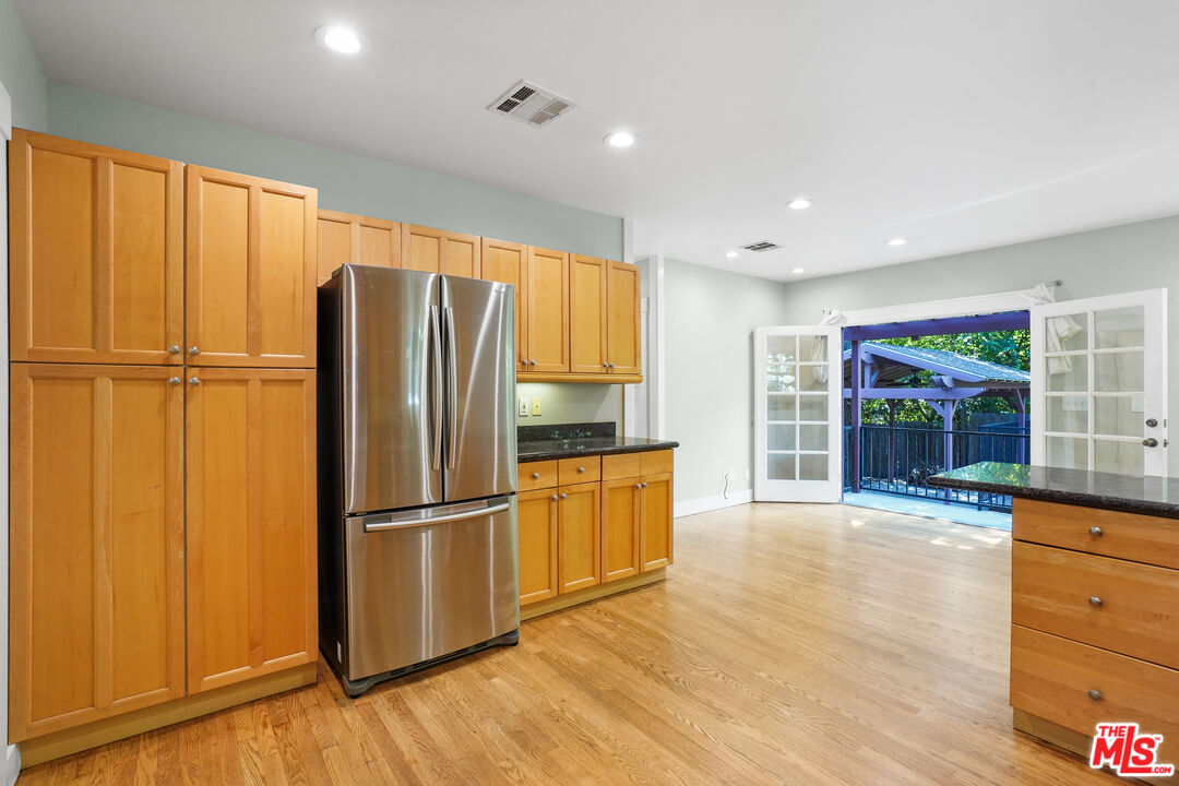 910 Bell Street Pasadena, CA 91104 - Photo 8 of 32 a kitchen with stainless steel appliances granite countertop a refrigerator and a stove top oven