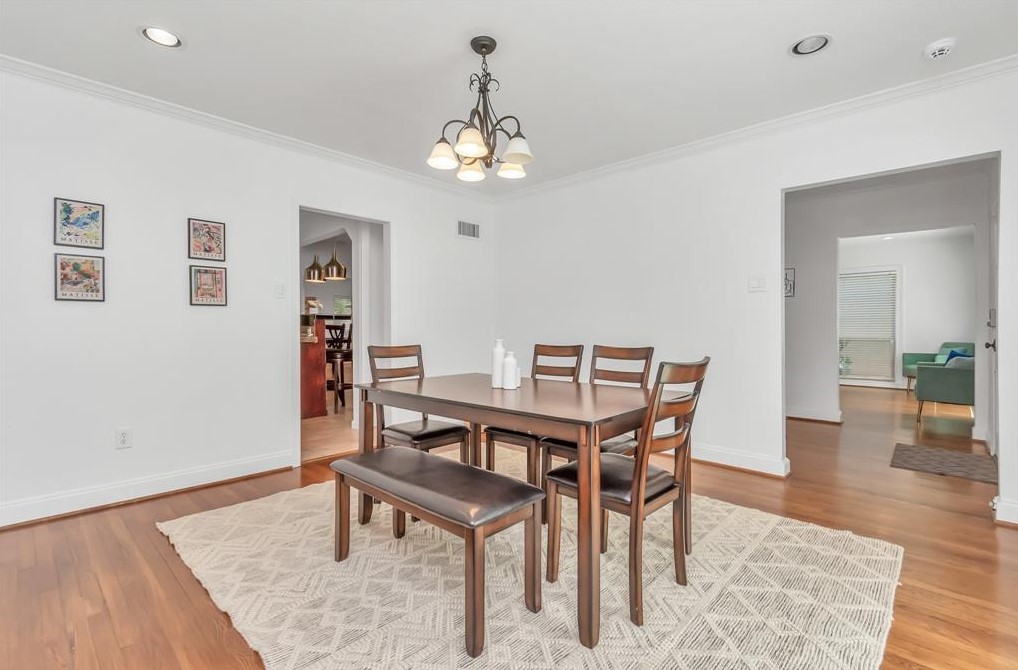 3215 Milburn Street Houston, TX 77021 - Photo 10 of 34 Current dining room with light fixture and hardwood flooring, located right off of the kitchen.