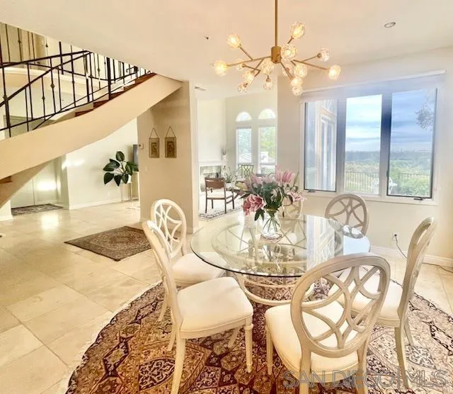 5225 Caminito Providencia Rancho Santa Fe, CA 92067 - Photo 12 of 14 a view of a dining room with furniture and a chandelier
