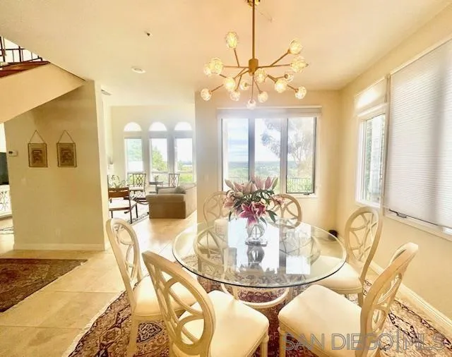 5225 Caminito Providencia Rancho Santa Fe, CA 92067 - Photo 6 of 14 a dining room with wooden floor a chandelier a glass table and chairs
