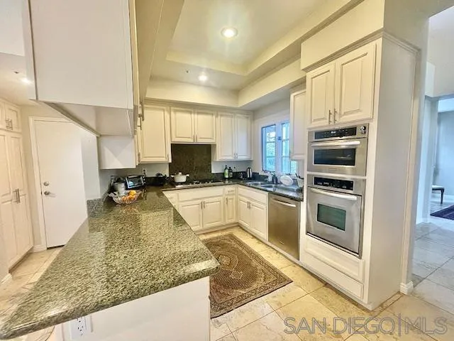 5225 Caminito Providencia Rancho Santa Fe, CA 92067 - Photo 7 of 14 a kitchen with stainless steel appliances granite countertop a stove a sink and a microwave