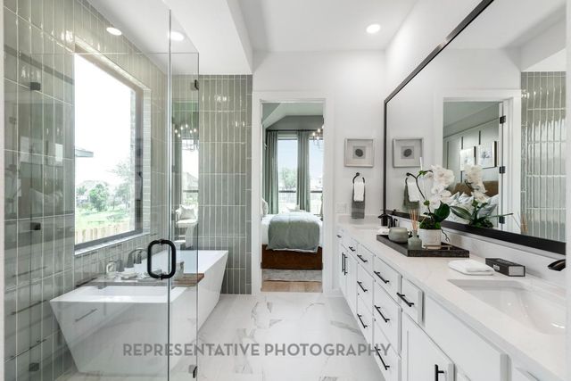 a bathroom with double vanity sinks a large mirror and a shower