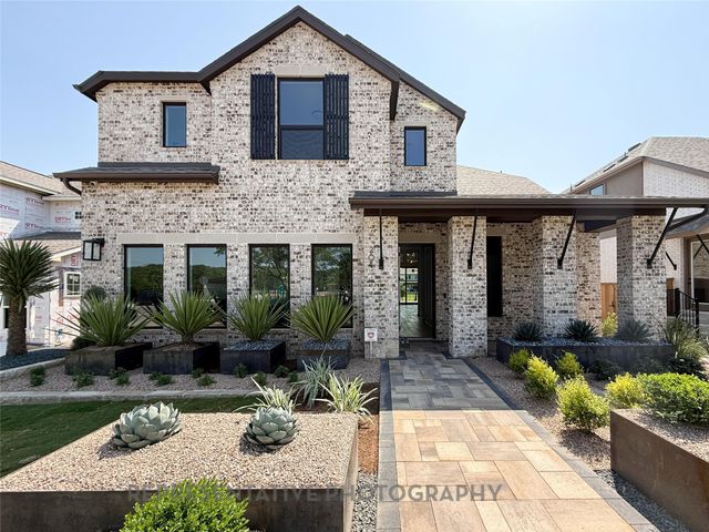 a front view of a house with porch and glass windows