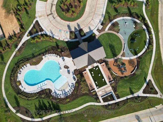 an aerial view of a house with swimming pool and outdoor seating