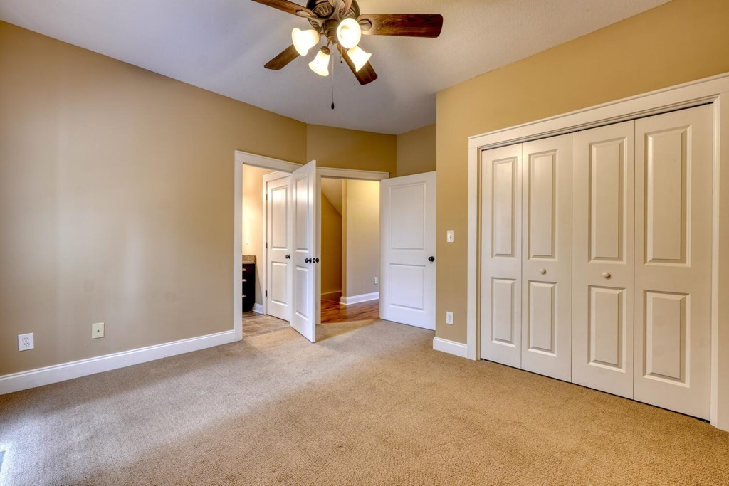 1401 Lakeside Road Hiawassee, GA 30546 - Photo 17 of 46 an empty room with a chandelier fan and a chandelier fan