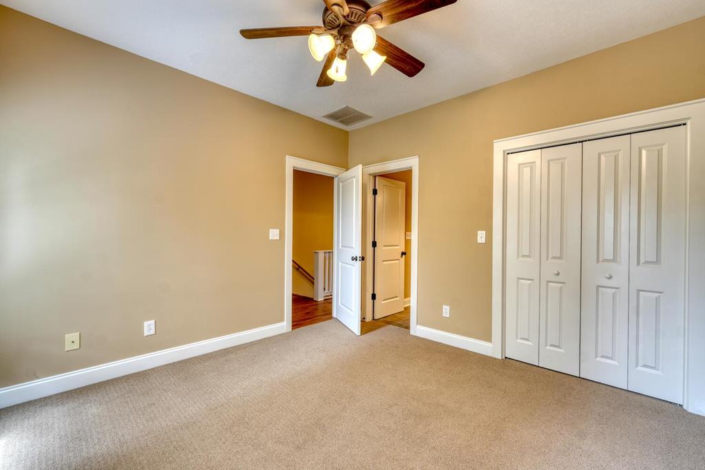 1401 Lakeside Road Hiawassee, GA 30546 - Photo 18 of 46 an empty room with closet and chandelier fan