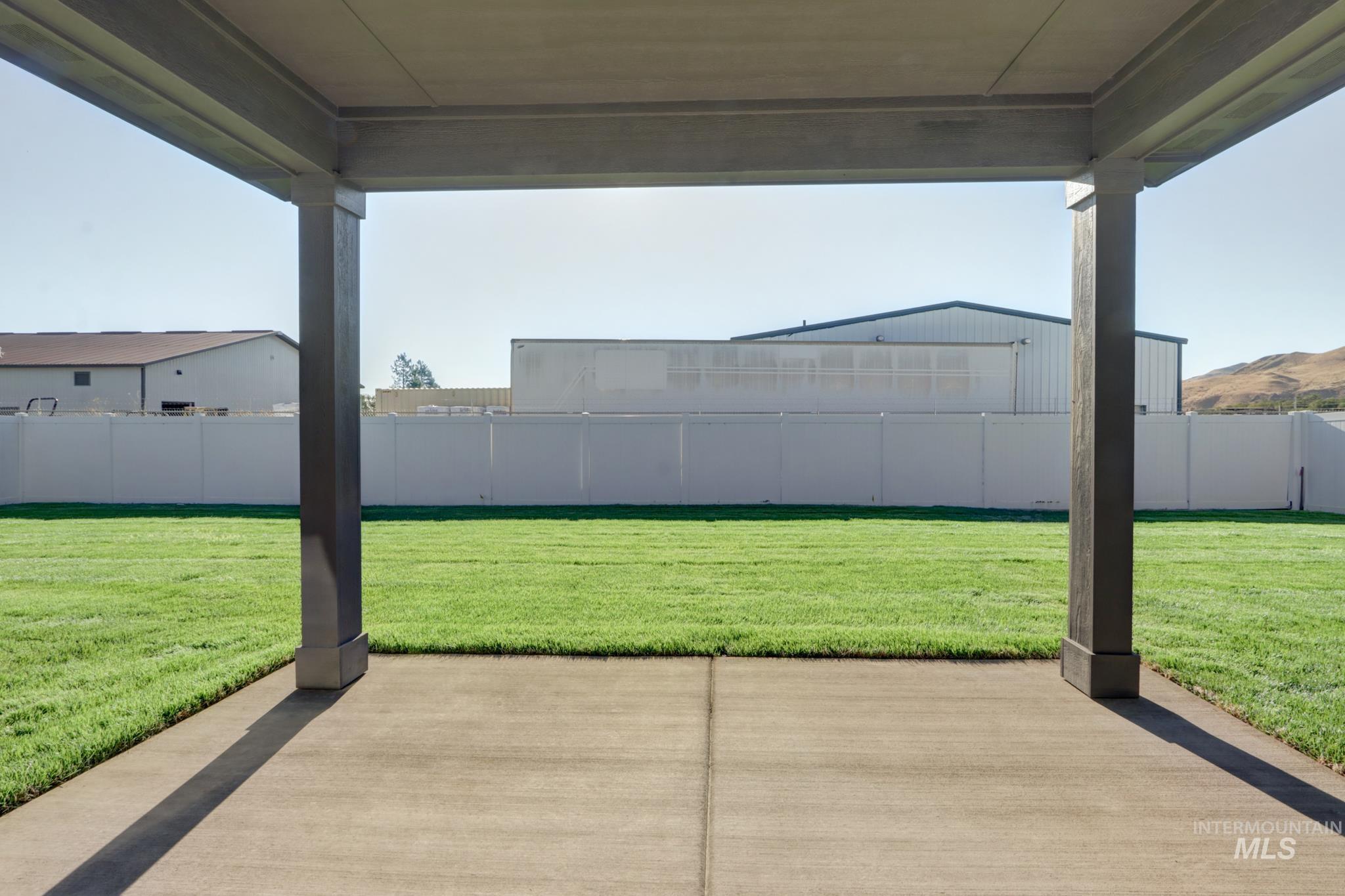 848 North 5th Street Nyssa, OR 97913 - Photo 38 of 49 Covered patio with a concrete slab, overlooking a green lawn and a perimeter fence