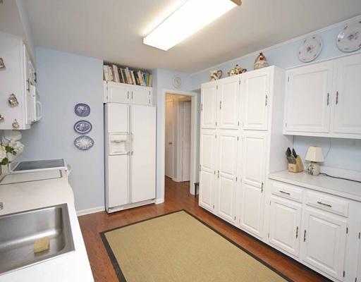 6 Middlesex Road Darien, CT 06820 - Photo 4 of 18 a kitchen with white cabinets and white appliances