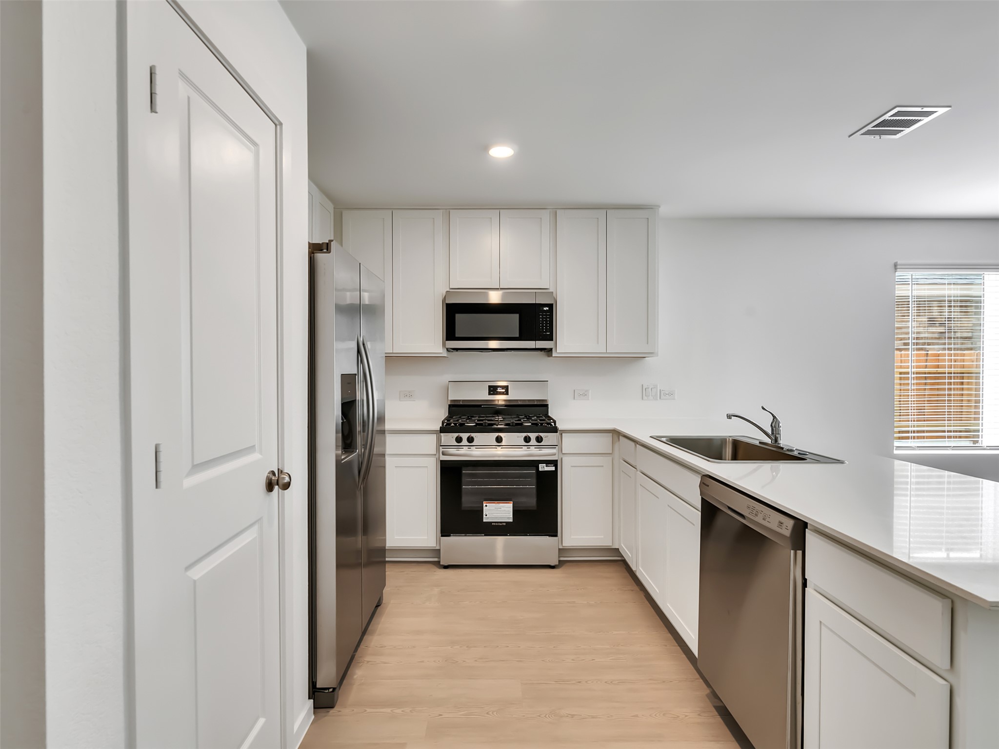 3041 Colusa Rdg Drive Katy, TX 77493 - Photo 7 of 26 a kitchen with stainless steel appliances granite countertop a stove and a refrigerator