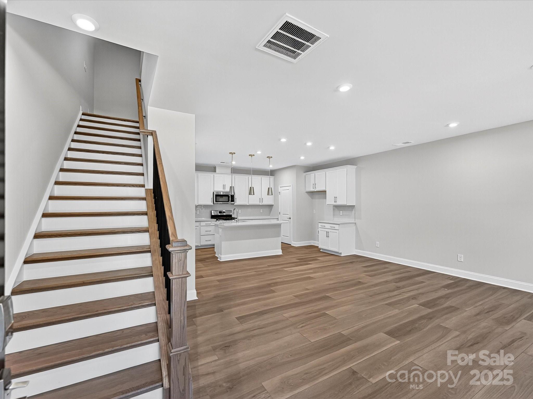 489 Nash Street Fort Mill, SC 29715 - Photo 2 of 24 a view of kitchen and hall with wooden floor