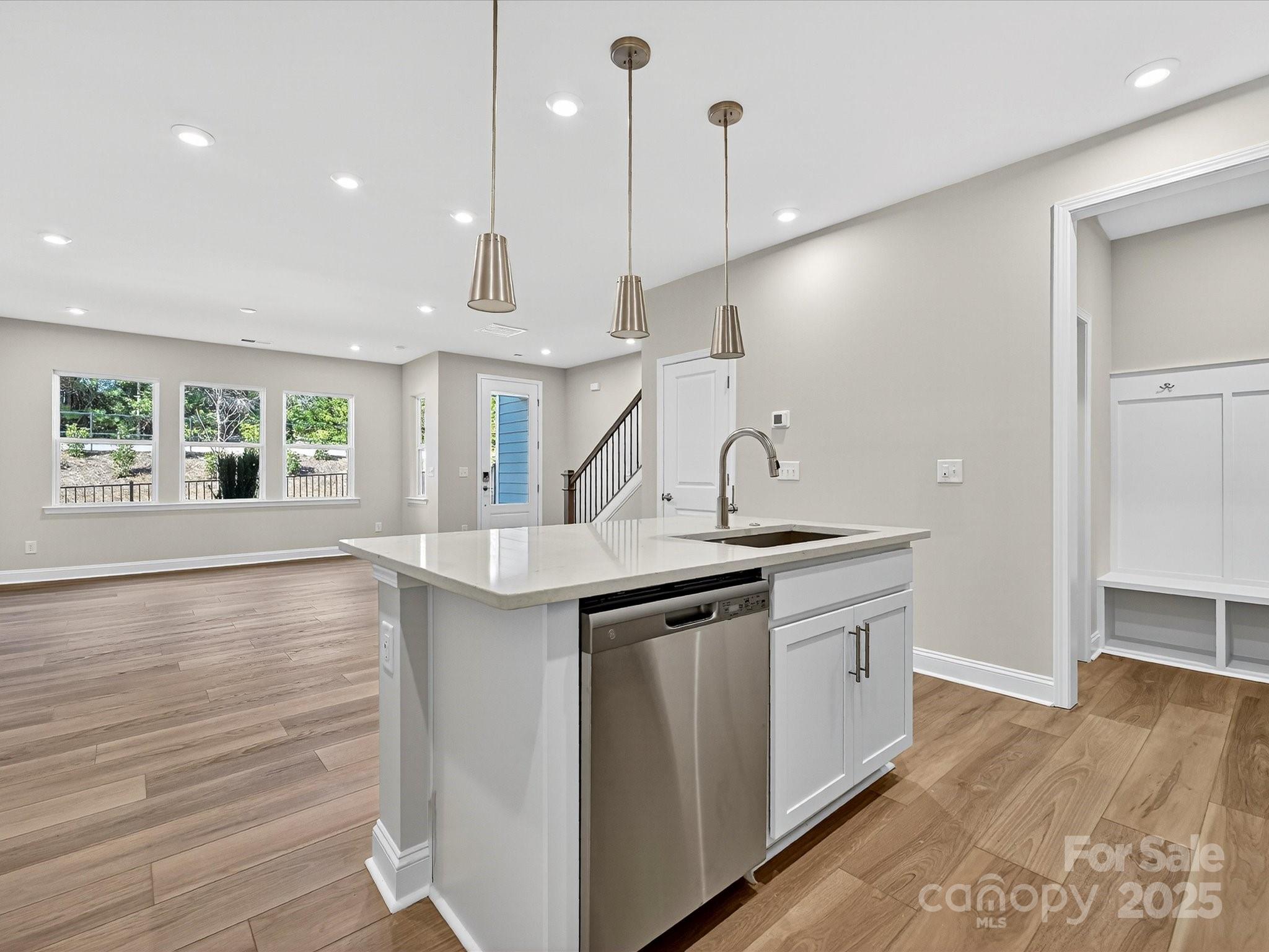 489 Nash Street Fort Mill, SC 29715 - Photo 8 of 24 a kitchen with stainless steel appliances granite countertop a sink a window and a wooden floor
