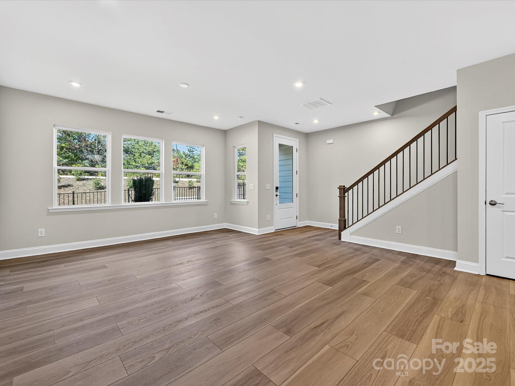 489 Nash Street Fort Mill, SC 29715 - Photo 10 of 24 a view of an empty room with wooden floor and a window